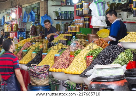 AGADIR, MOROCCO - AUGUST 28: Sellers offer fruit and vegetables in the Suk - city market on 28 August 2014 in Agadir, Marocco