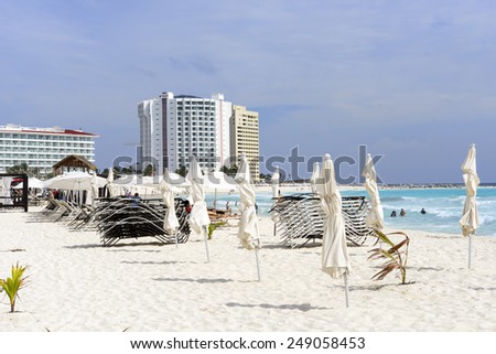 Beach, beautiful weather, sun loungers and umbrellas waiting for tourists in Cancun, Mexico. This is one of the best beaches in the Mexico.