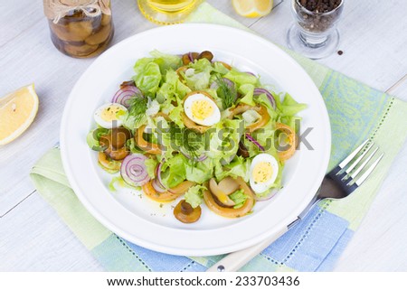 Fresh salad with mushrooms, squid and quail eggs