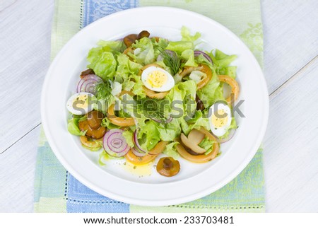 Fresh salad with mushrooms, squid and quail eggs