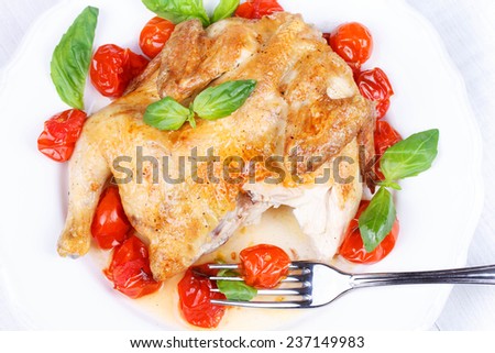 Roast chicken with tomatoes cherry, green basil and garlic