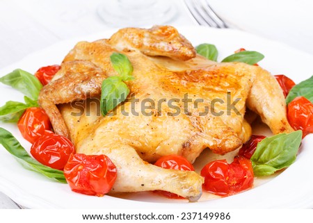 Roast chicken with tomatoes cherry, green basil and garlic
