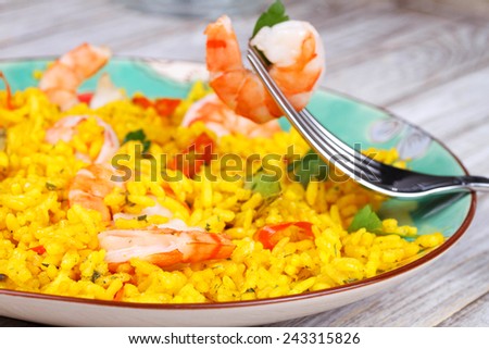 Plate of Shrimps Risotto garnished with fresh parsley and red chili pepper