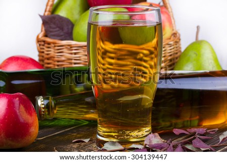 Glass and bottles of cider. Apples and pears