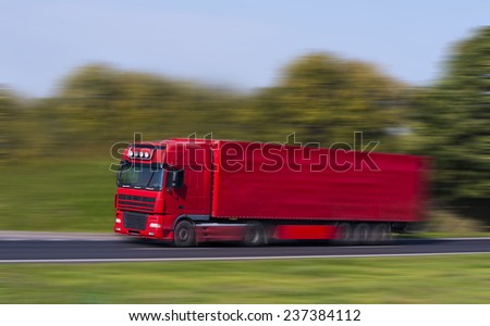 Red Truck on a fast express road, motion blur