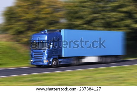 Blue Truck on a fast express road, motion blur