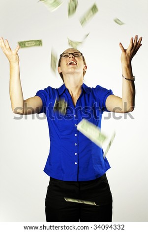 An attractive woman catching falling money