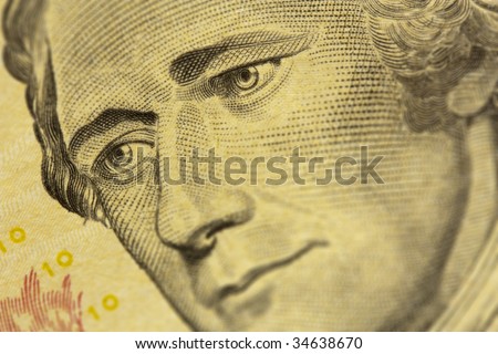 A close up shot of Alexander Hamilton\'s eyes, from a ten dollar bill