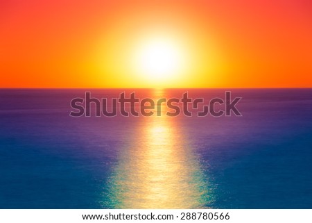Sunset panorama over a flat sea. Long time exposure