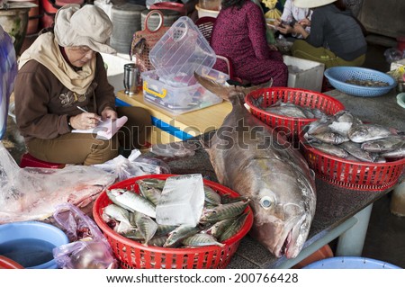 Vietnam - Hoi An - January 6, 2014 Unidentified women sells fish at the fish market in Hoi An. Hoi An is an UNESCO World Heritage site and its fish market is a major attraction for tourists.