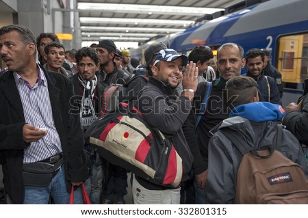 Munich, Germany -September 9, 2015: Refugees arriving at the trainstation in Munich. The asylum seekers from Syria, Afghanistan and other insecure countries are happy to arrive in Germany.