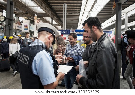 Munich, Germany -September 22, 2015: Refugees arriving at the trainstation in Munich. The asylum seekers from Syria, Afghanistan and other insecure countries are happy to arrive in Germany.