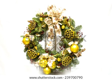 Christmas green wreath from firs brunches with decoration - dry oranges, poinsettia flowers and cones. On wooden background with copy space.