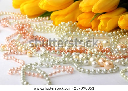 yellow tulips tied up with a ribbon isolated on white background, yellow tulips , pearls