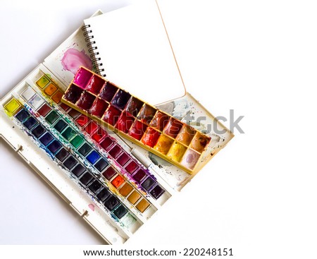 Two watercolor sets with spiral notebook on white background