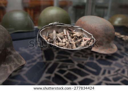 Bullets and cartridges in war helmet