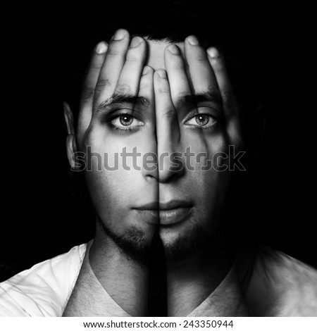 Surreal portrait of a man covering his face and eyes with his hands.Double exposure