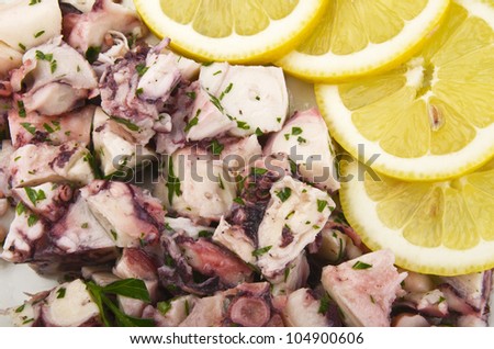 octopus salad close up with sliced of lemon