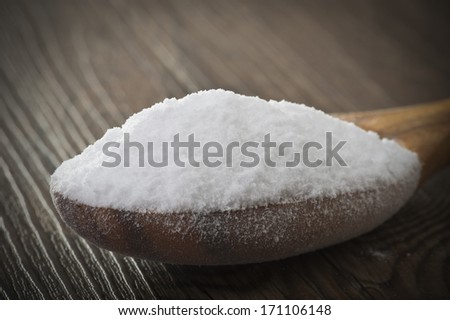 wood spoon of baking soda close up on table
