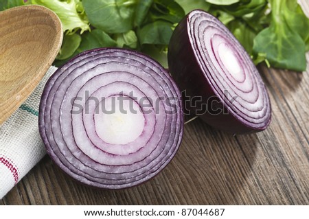 Onion cut in half close up on wood table