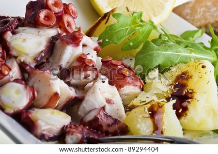 octopus salad with lemon slice and potatoes
