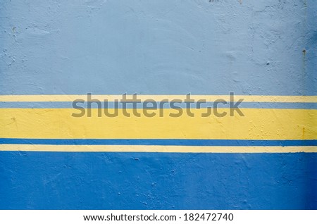 Blue painted wall and yellow line