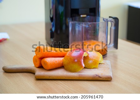 Fresh carrot and apple juice and electrical juice extractor