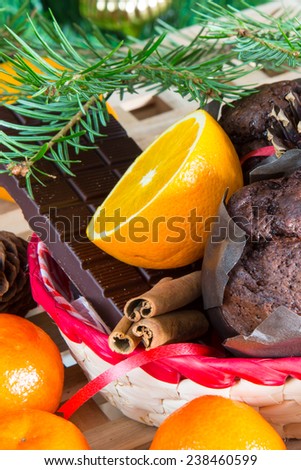 Christmas still-life with close up cupcakes, oranges and chocolate