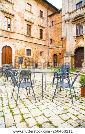 MONTEPULCIANO, ITALY - NOVEMBER, 15, 2014 : Empty tables at the cafe at the main square in Montepulcino - Tuscany, Italy