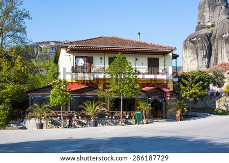 Meteora, Greece - April 27, 2015: Outdoor view of the traditional Greek tavern surrounded with Meteora cliffs in Kastraki village, Greece