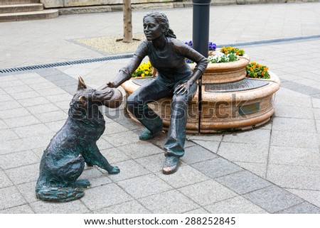 Budapest, Hungary - March 31, 2015: A bronze statue of a girl with dog with ball on Danube promenade, Budapest , Hungary. Sculpted by Raffay David