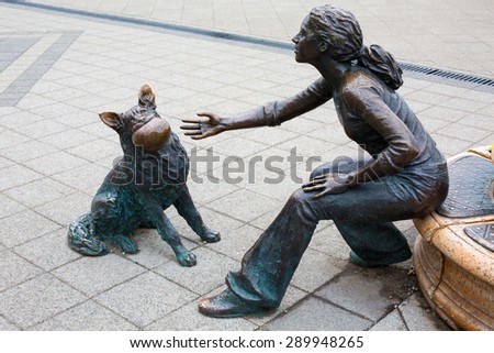 Budapest, Hungary - March 31, 2015: Statue sculpture bronze of girl with dog with ball on Danube promenade, Budapest , Hungary. Sculpted by Raffay David