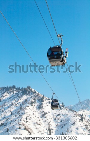Almaty, Kazakhstan - March, 2, 2014:  Ski lift, Gondola lift, cable car at Medeo to Shymbulak route near Almaty against mountain background