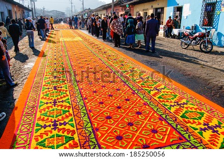 ANTIGUA, GUATEMALA - APRIL 10, 2009: Holy Week carpet (or alfombra) made in the path of a religious procession using wooden or cardboard stencils and dyed sawdust