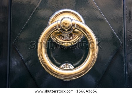 circle iron door-handle on black door