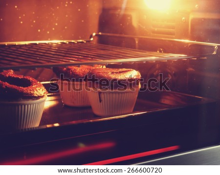 Chocolate cake in oven with vintage filter