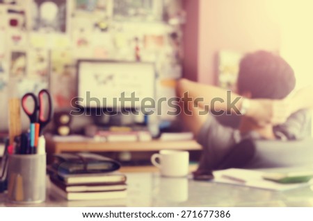 Blurred background : workingman in workspace with vintage filter