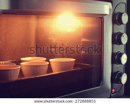 Cup cake in oven with vintage filter