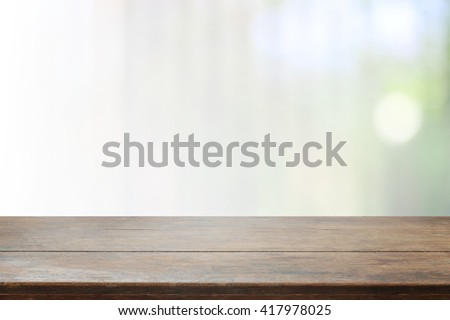 Wood table top and blurred bokeh background with vintage filter - can used for display or montage your products.