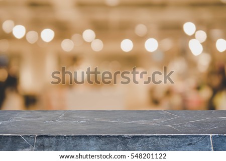Stone table top and blurred restaurant interior background with vintage filter - can used for display or montage your products.