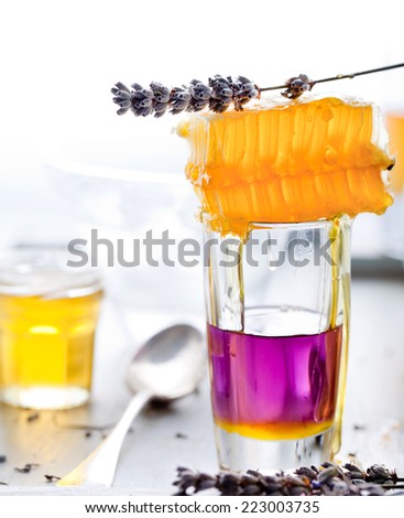 Lavender honey, honeycomb with lavender flowers on a white background
