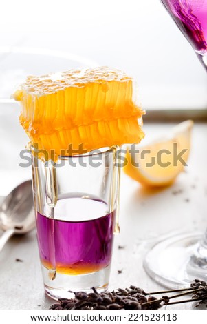 Martini, lavender, honey, lemon cocktail on a white background.