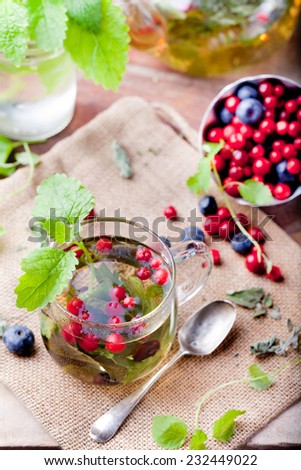 Herbal tea with fresh berries on a wooden background. Romantic autumn, summer background. Traditional Russian tea