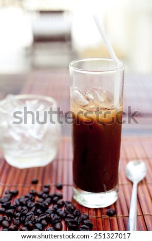 Traditional Vietnamese, Thai Ice coffee with coffee beans on a wooden background