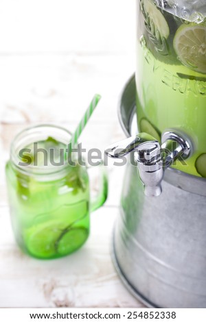 Lemonade, water, beverage dispenser with beverage jars on a white background