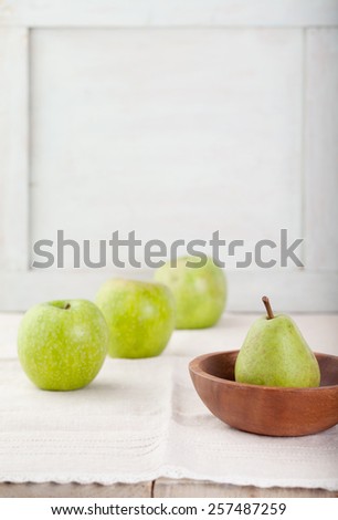 Green Apples and pear on a white wooden background. Copy space.