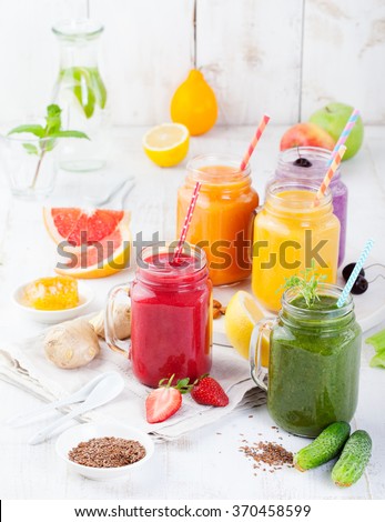 Smoothies, juices, beverages, drinks variety with fresh fruits and berries on a white wooden background