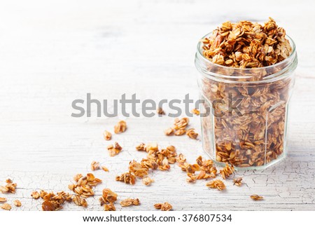Healthy breakfast. Fresh granola, muesli in a glass jar Organic oat, almond and sunflower seeds Copy space