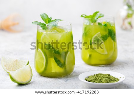 Matcha iced green tea with lime and fresh mint on a marble background