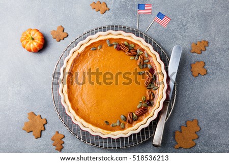 Pumpkin pie, tart made for Thanksgiving day with American flag Grey stone background. Top view. Copy space